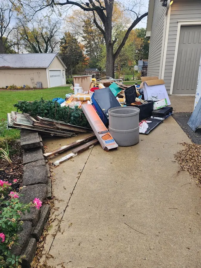Dumpster being loaded with debris for 12 Yard Dumpster Rental in Bolton